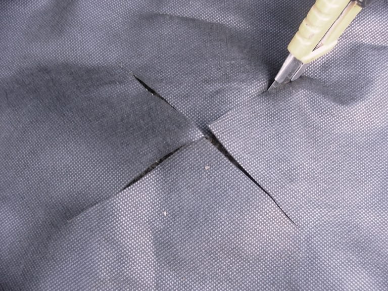 Cut holes in Weed Mat